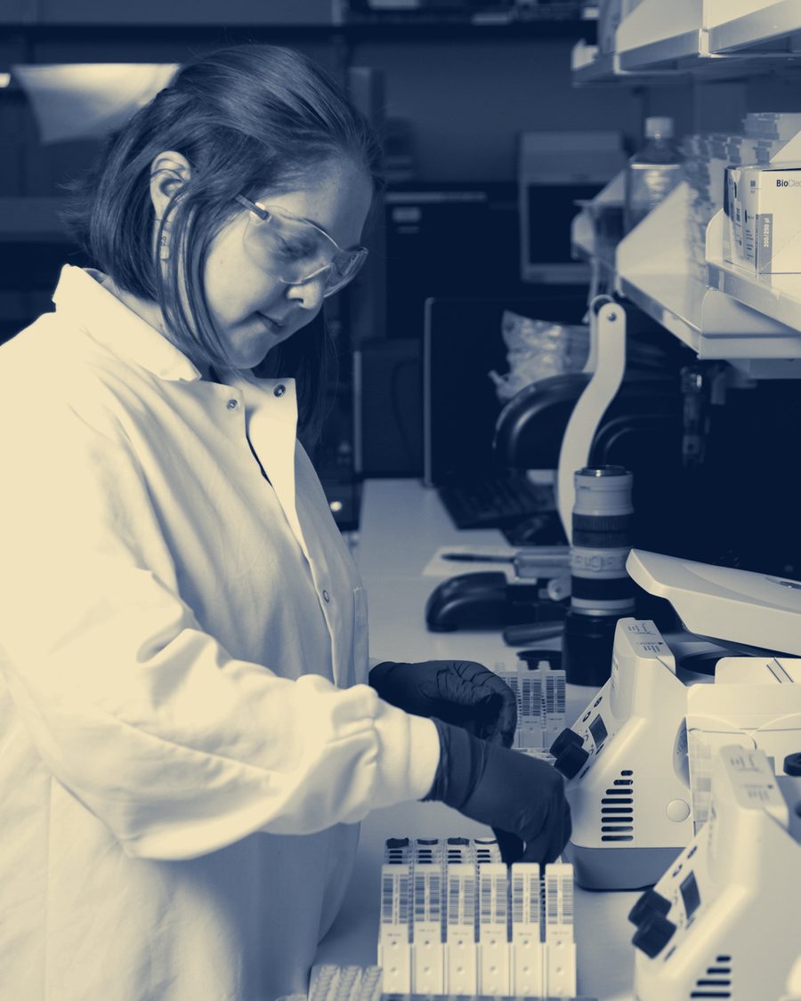 A laboratory researcher preparing samples at a bench